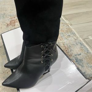 Woman’s knee length boots.